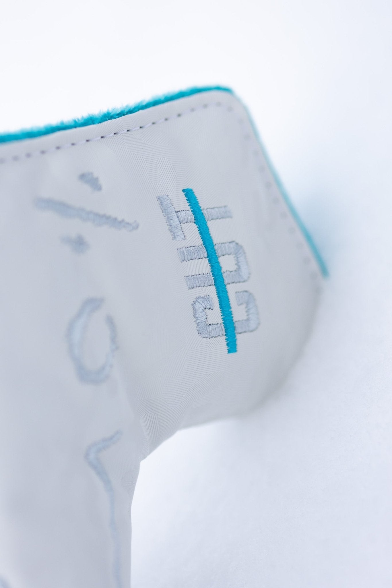 No Bogeys White Blade Cover with embroidered blue and white logo and soft turquoise lining golf headcover close-up.