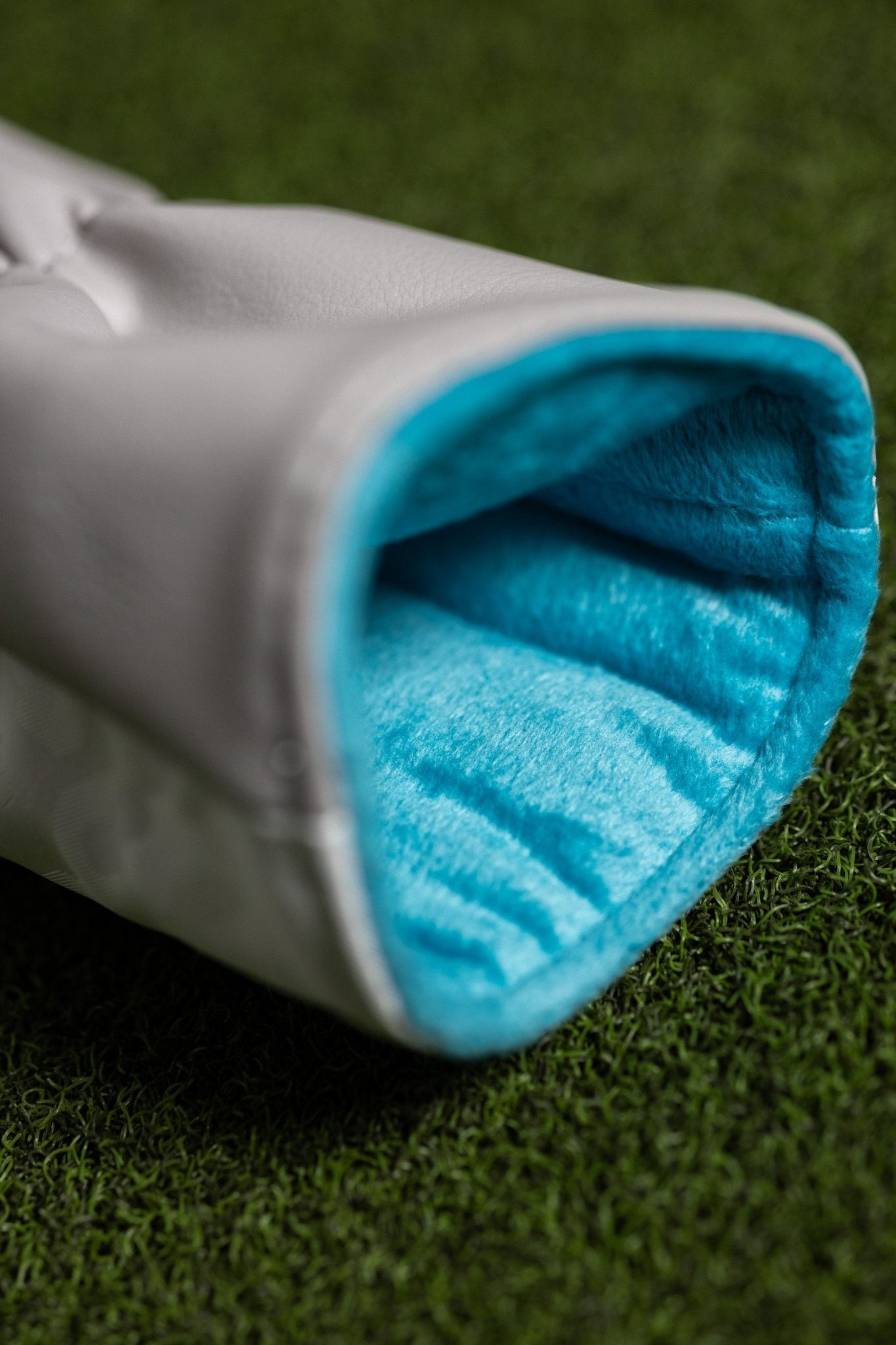 No Bogeys White Fairway Cover showing soft blue interior lining designed for golf gear protection on green turf.