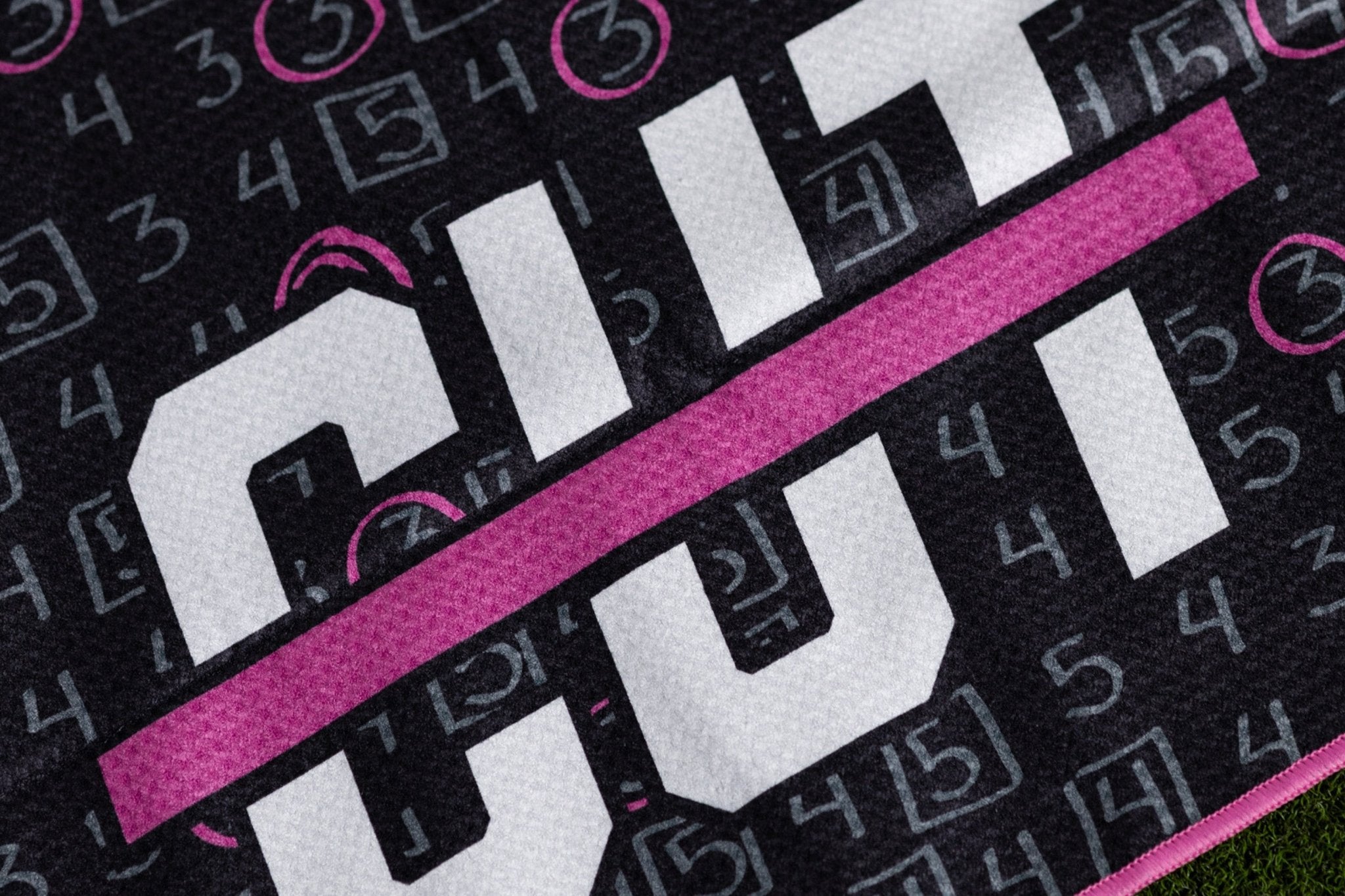 Close-up of a black and pink golf scorecard featuring the Cutline E-Gift Card branding on textured fabric.