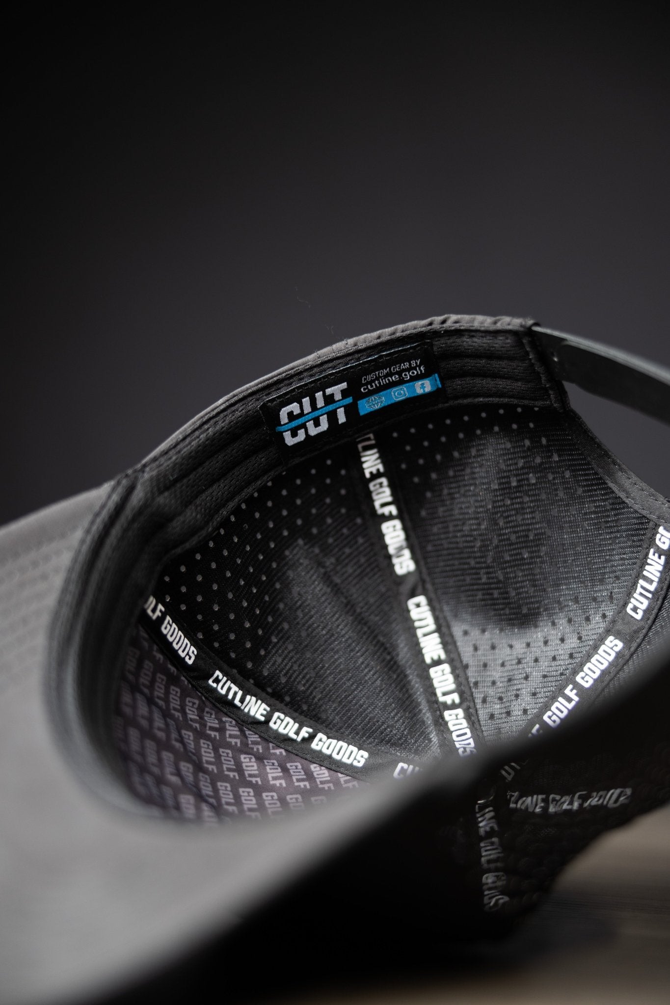 Inside view of the Blackout Cutline Hat showing branded sweatband and adjustable strap for golf gear enthusiasts.