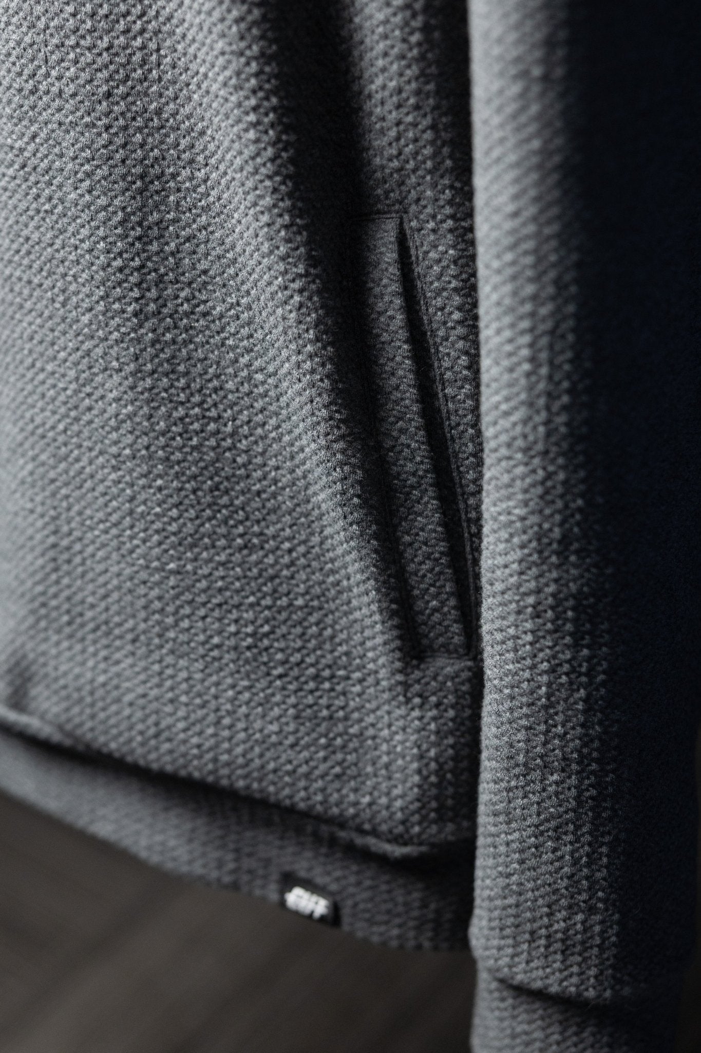 Close-up of waffle knit texture and pocket detail on Waffle Knit Cobalt Grey GOLF Hoodie, casual golf apparel piece.