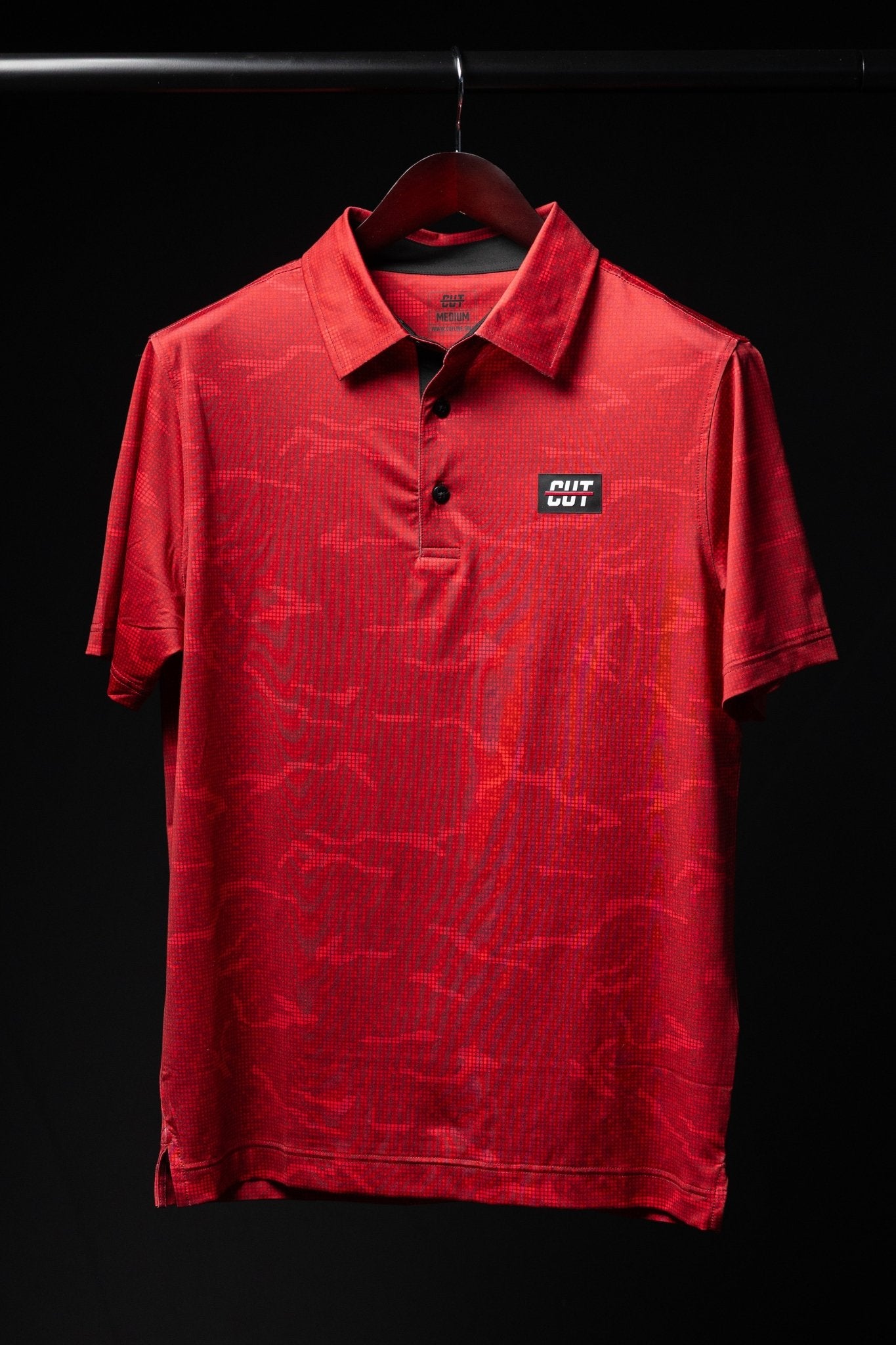 True Red Tech Camo Polo with subtle red camo pattern, short sleeves, and button collar, ideal for golf apparel.