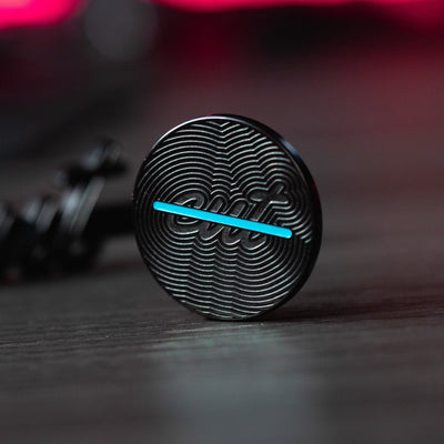 Cut "LINE" Alignment Ball Marker with textured black surface and blue alignment line for precise golf aiming adjustments