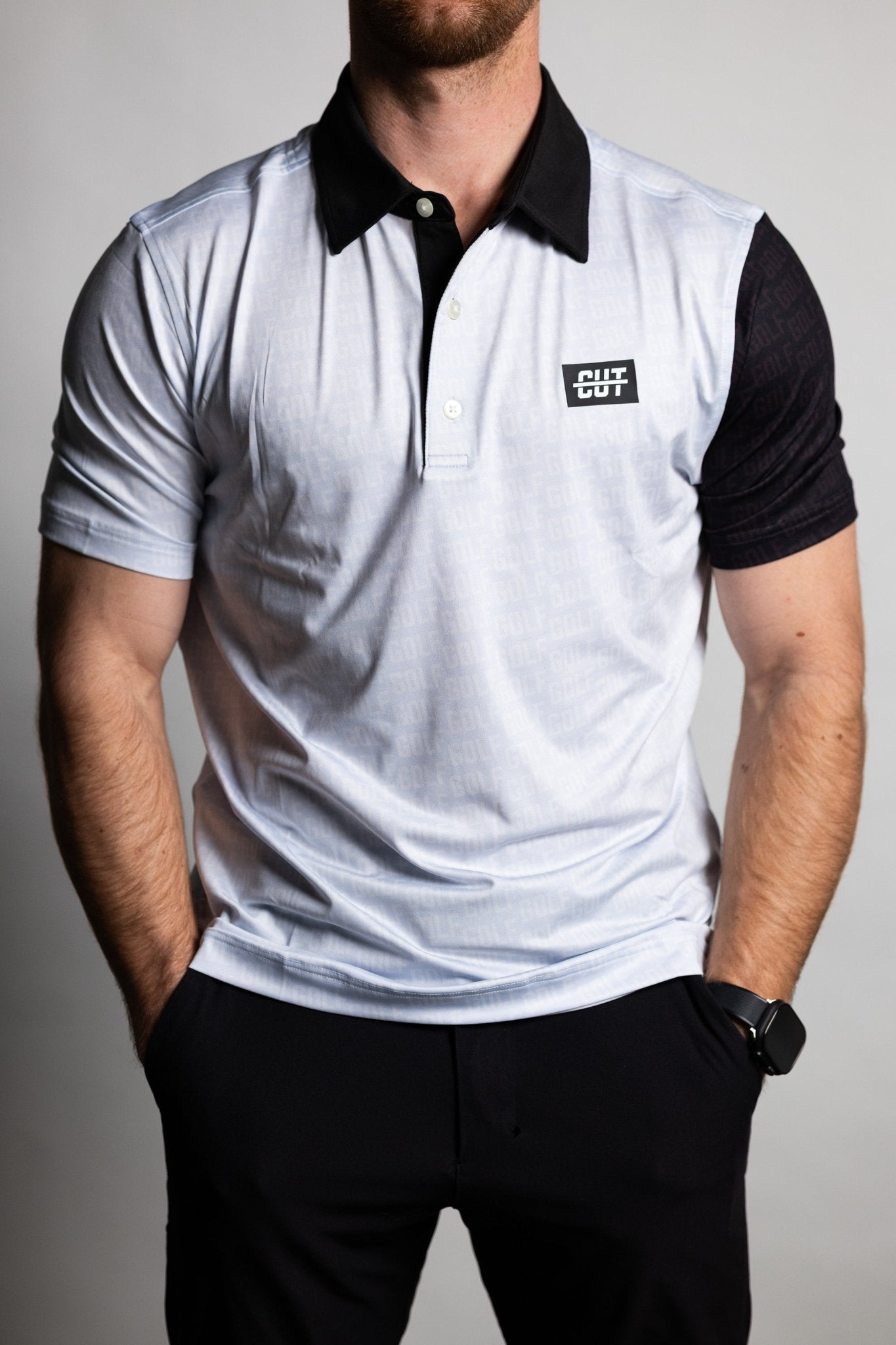 Man wearing GOLF Pattern Off White Polo with black collar and contrasting black sleeve, styled for golf apparel look