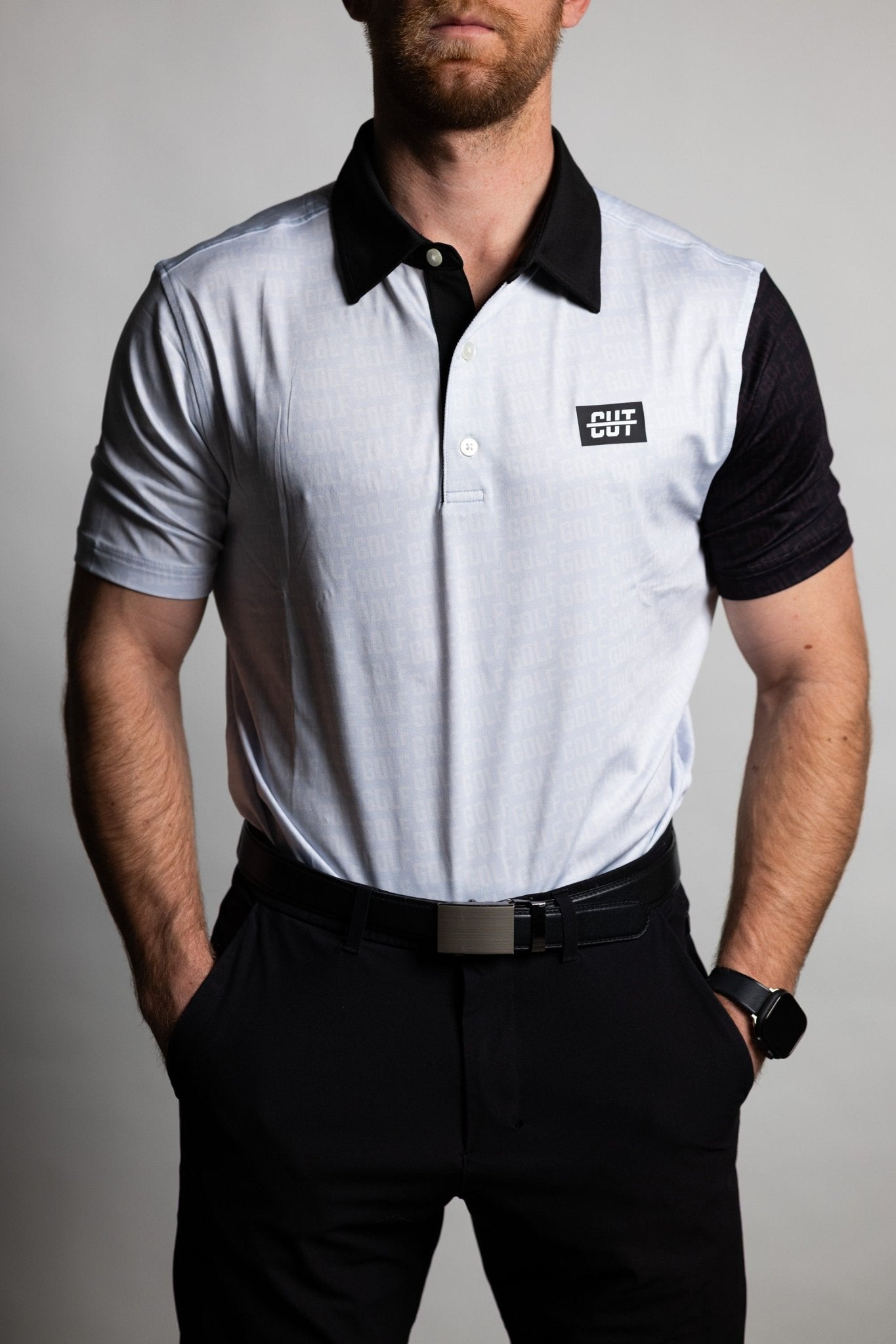 Man wearing GOLF Pattern Off White Polo with black collar and sleeves styled with black pants and belt