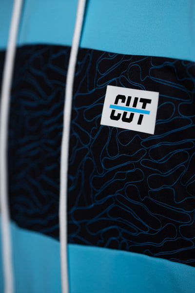Close-up of teal and black patterned fabric with white logo on the Teal Topo Athletic Hoodie golf gear piece