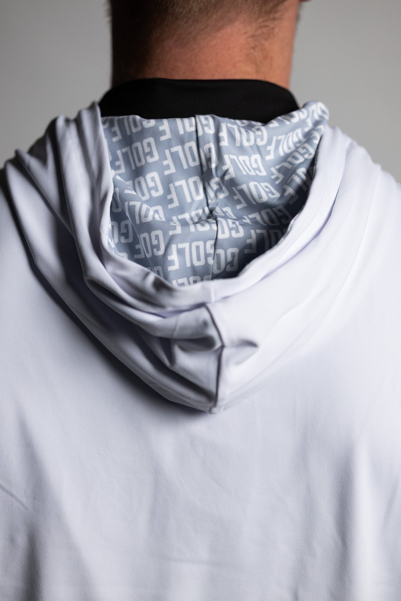 Close-up of back hood with repeated text pattern on the hood lining of the GOLF Whiteout Athletic Hoodie