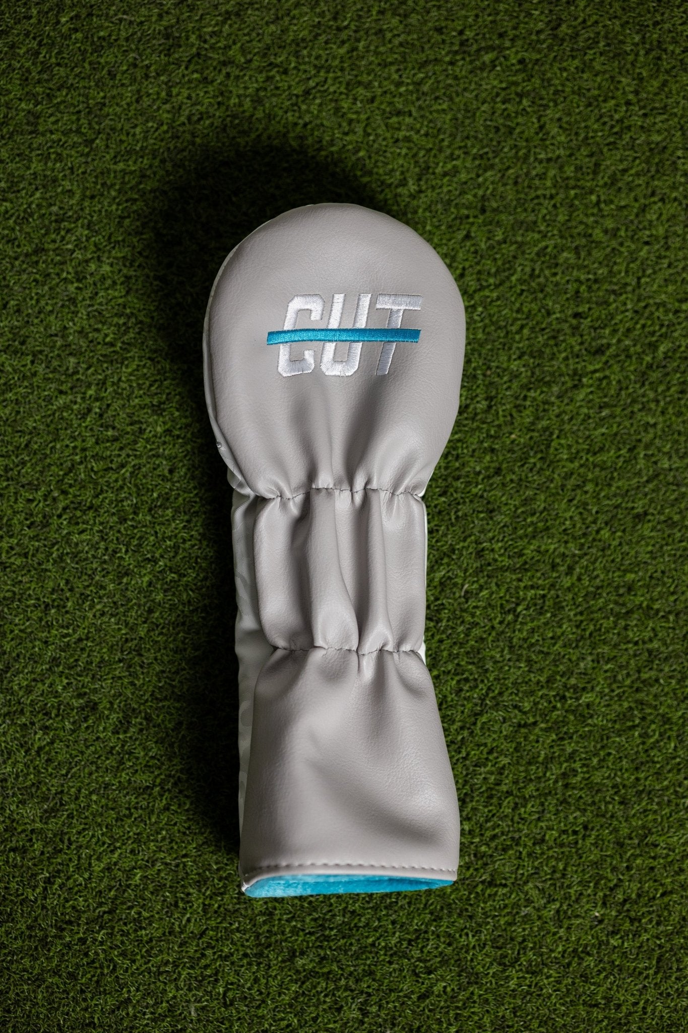 No Bogeys White Fairway Cover with blue and white embroidered logo on artificial green grass background