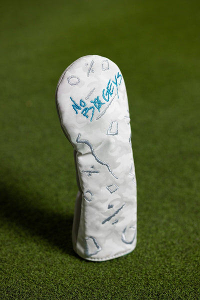 No Bogeys White Fairway Cover with abstract embroidered designs standing on green grass golf course.