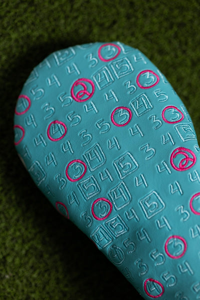 Scorecard Teal Fairway Cover with embossed golf scorecard numbers and pink stitched circles on teal material.