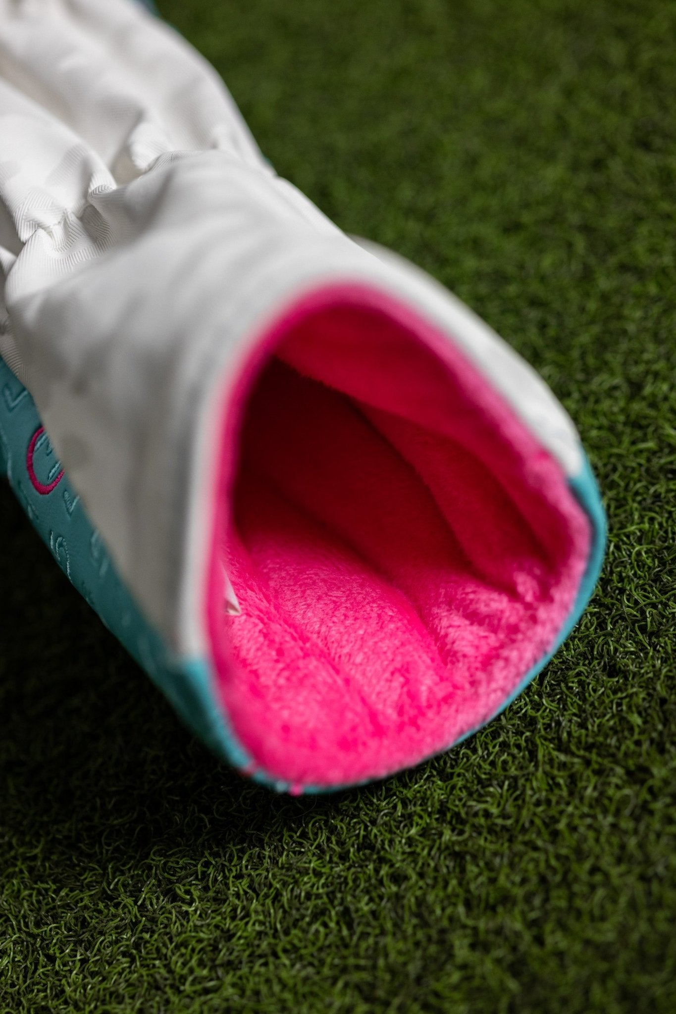 Scorecard Teal Fairway Cover with bright pink soft interior lining on green grass background