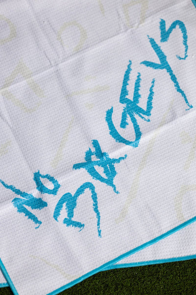 No Bogeys Oversized Towel with textured white fabric and bright blue lettering on grass background