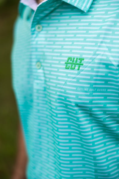 Close-up of a mint green Minted Lines Polo with white linear pattern and Cutline Golf Goods logo on chest.