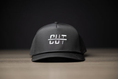 Blackout Cutline Hat in black with white embroidered Cutline logo, designed as stylish golf gear accessory.