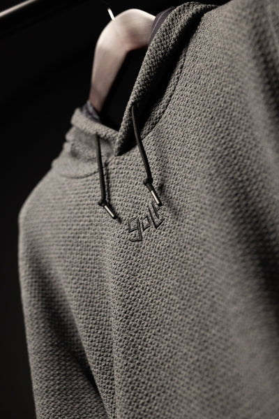 Close-up of Waffle Knit Cobalt Grey GOLF Hoodie showing textured fabric and embroidered GOLF logo on chest
