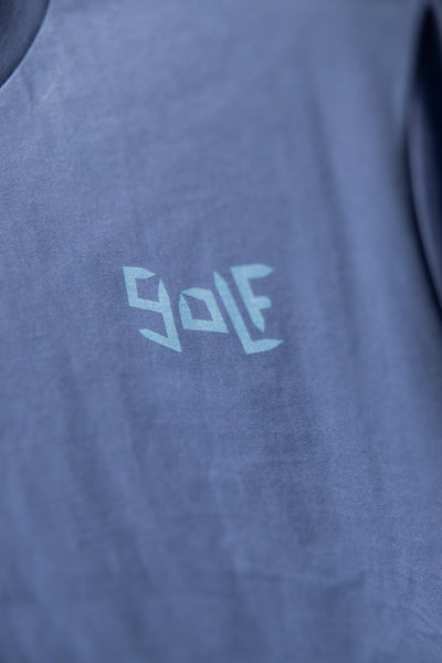 Close-up of blue Play More Golf T-Shirt with abstract golf text design in light blue on soft fabric
