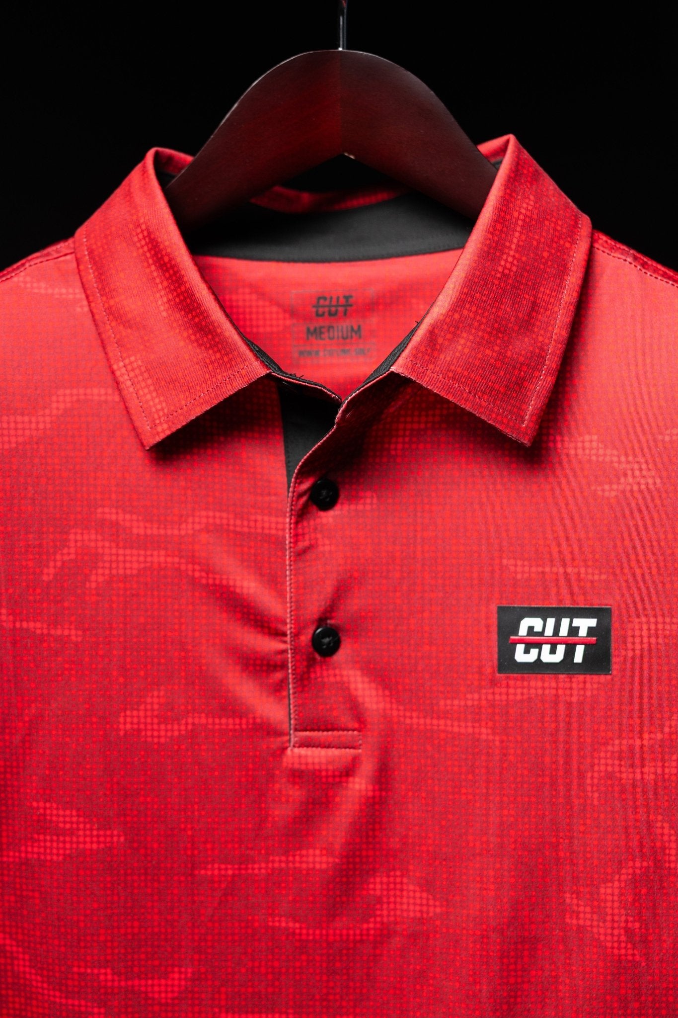 True Red Tech Camo Polo with subtle camouflage pattern, black buttons, and CUT logo on chest in golf apparel style